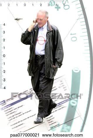 Stock Image - Man talking on phone and walking on computer screen, framed with systems of measurements, montage. Fotosearch