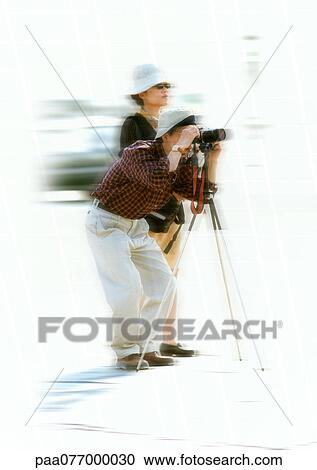 Stock Image - Tourists taking photos, blurred. Fotosearch