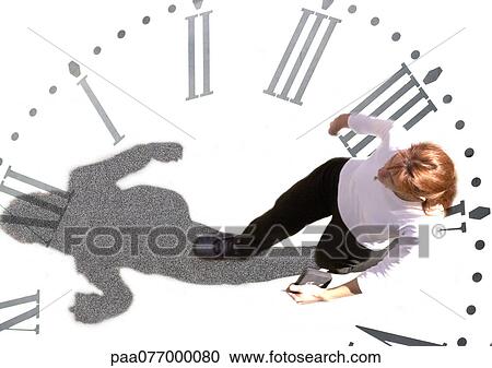 Stock Image - Woman walking on clock, montage. Fotosearch