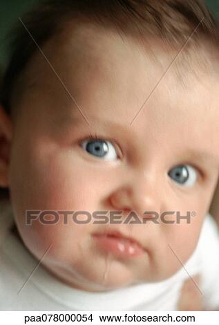 Baby drooling and looking at camera, close-up, blurred. View Large Photo Image Picture - Baby drooling and looking at camera, close-up, blurred.. Fotosearch