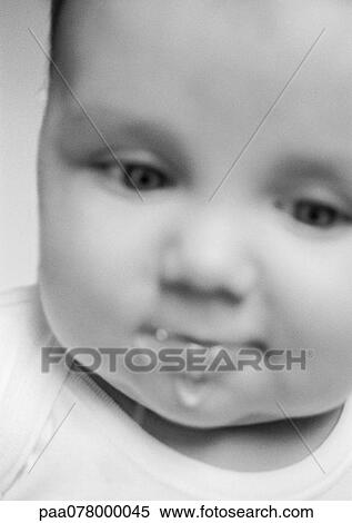 Stock Photography - Baby drooling, blurred, close-up, B&W.. Fotosearch