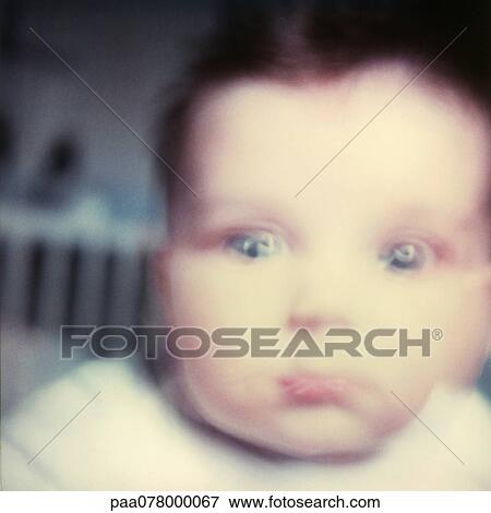 Stock Photo - Baby looking at camera, close-up, blurred.. Fotosearch