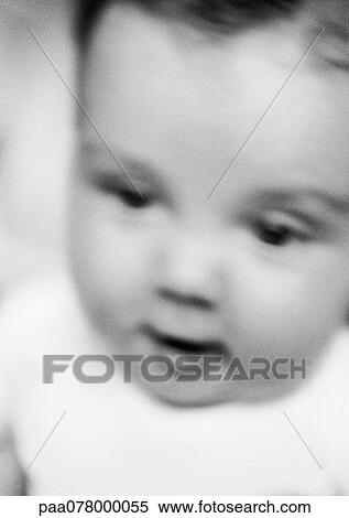 Stock Photography - Baby looking down, blurred, close-up, b&w. Fotosearch