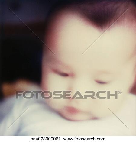 Baby looking down, close-up, blurred. View Large Photo Image Stock Image - Baby looking down, close-up, blurred.. Fotosearch