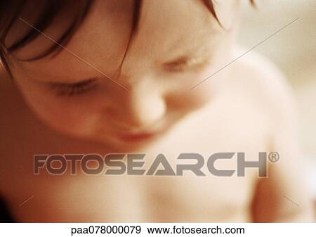Stock Photo - Baby looking down, close-up.. Fotosearch