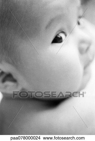 Baby looking over shoulder, close-up, B&W. View Large Photo Image Picture - Baby looking over shoulder, close-up, B&W. . Fotosearch