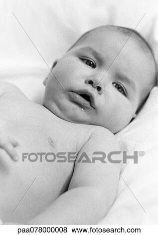 Stock Photo - Baby lying down, looking at camera, B&W.. Fotosearch