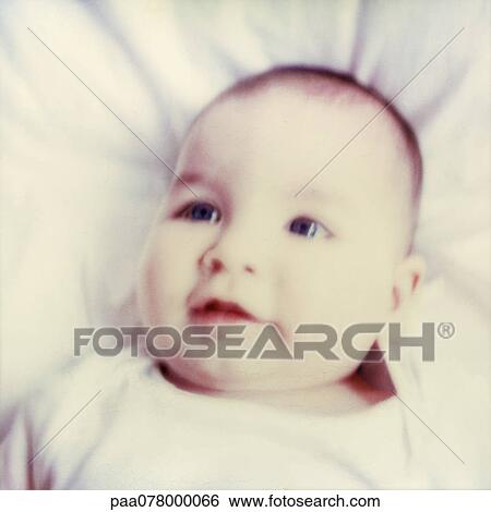 Stock Photograph - Baby lying on back, close-up, blurred. Fotosearch