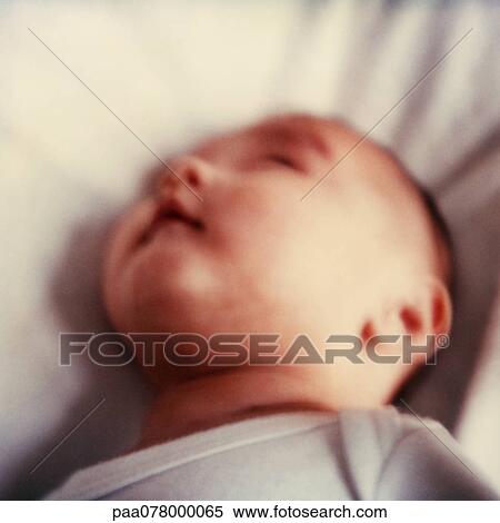 Baby lying on back, looking back, close-up, blurred. View Large Photo Image Stock Photography - Baby lying on back, looking back, close-up, blurred.. Fotosearch