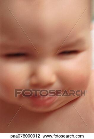 Baby sticking tongue out, squinting, blurred, close-up. View Large Photo Image Stock Image - Baby sticking tongue out, squinting, blurred, close-up.. Fotosearch