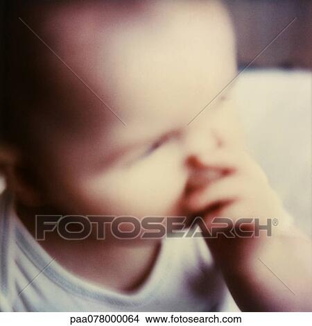 Picture - Baby sucking thumb, close-up, high angle view, blurred.. Fotosearch