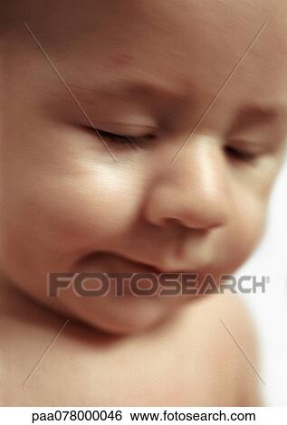 Stock Photograph - Baby with eyes closed, close-up, side view.. Fotosearch