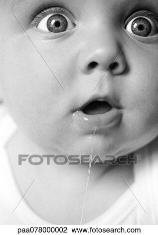 Baby with mouth open, drooling, eyes wide open, looking out of frame, extreme close-up, B&W. View Large Photo Image Stock Image - Baby with mouth open, drooling, eyes wide open, looking out of frame, extreme close-up, B&W.. Fotosearch