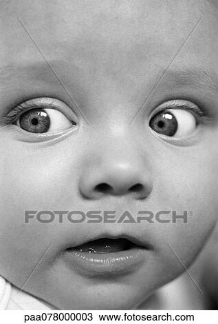 Stock Image - Baby's face, looking to the side, close-up, B&W.. Fotosearch