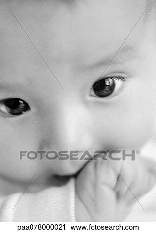 Baby's face with hand in mouth, close-up, B&W. View Large Photo Image Stock Image - Baby's face with hand in mouth, close-up, B&W.. Fotosearch