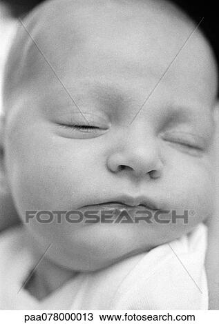 Stock Image - Baby's head, eyes closed, B&W.. Fotosearch