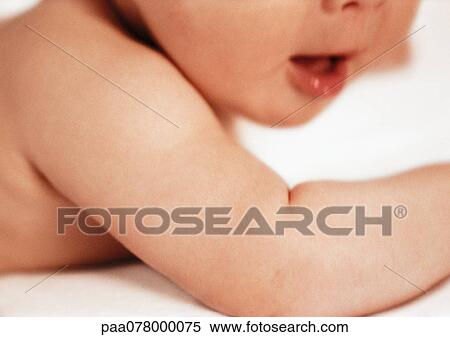 Partial view of baby's arm and face with open mouth, close-up View Large Photo Image Stock Photography - Partial view of baby's arm and face with open mouth, close-up. Fotosearch