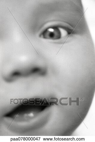 Stock Photo - Partial view of baby's face, mouth open, close-up, B&W.. Fotosearch