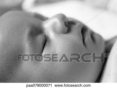 Stock Image - Sleeping baby's face, side view, close-up, B&W.. Fotosearch
