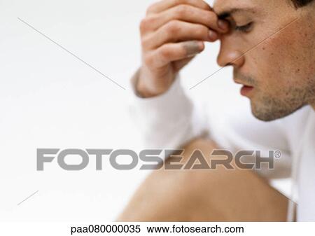 Man holding bridge of nose with fingers, side view, close-up View Large Photo Image Stock Photography - Man holding bridge of nose with fingers, side view, close-up. Fotosearch