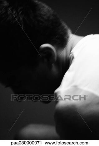 Stock Image - Man leaning head forward, blurred, close-up, black and white.. Fotosearch