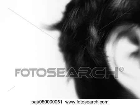Stock Image - Man's ear, close-up, blurred black and white.. Fotosearch