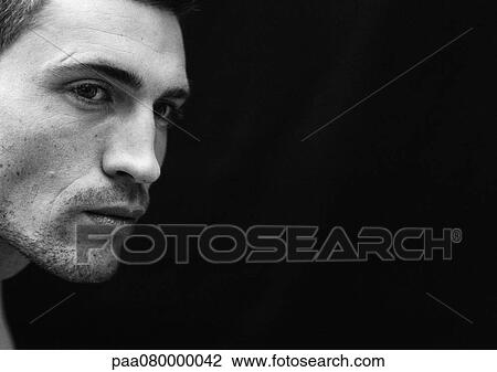Stock Image - Man's face, close-up, black and white.. Fotosearch