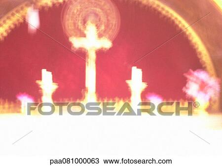 Stock Image - Israel, Jerusalem, cross and candles on altar in church, blurred. Fotosearch