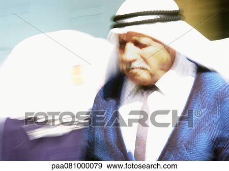 Stock Photo - Israel, Jerusalem, elderly man wearing keffiyeh, close-up, blurred. Fotosearch