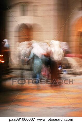 Stock Photo - Israel, Jerusalem, group of women wearing head coverings, rear view, blurred. Fotosearch