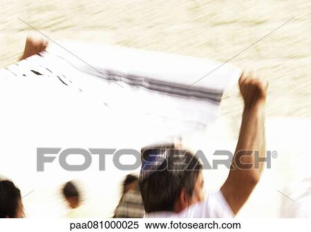 Stock Photography - Israel, Jerusalem, man holding tallith above head, blurred. Fotosearch