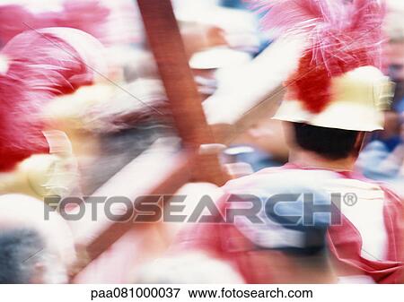 Stock Photo - Israel, Jerusalem, man in costume carrying cross, blurry.. Fotosearch