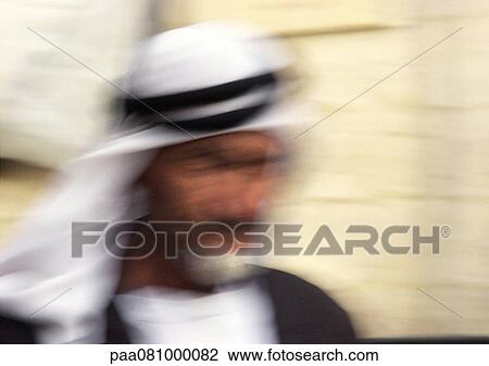 Stock Image - Israel, Jerusalem, man wearing keffiyeh, close-up, blurred. Fotosearch