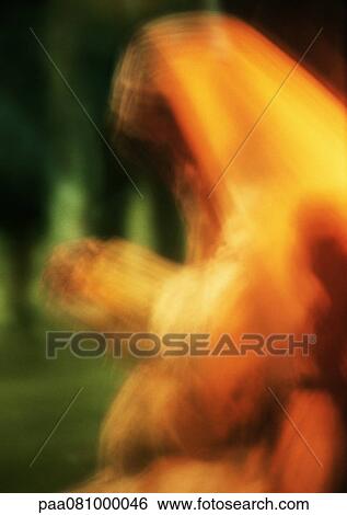 Stock Photograph - Israel, Jerusalem, nun praying, waist up, blurred.. Fotosearch
