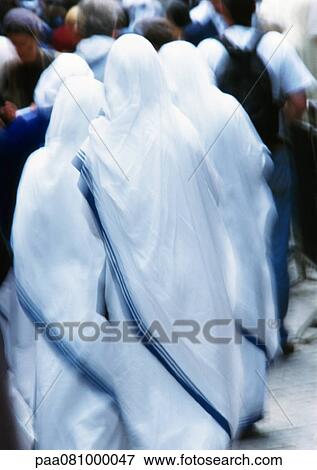Israel, Jerusalem, nuns clothed in white looking toward crowd, rear view, blurry. View Large Photo Image Stock Photo - Israel, Jerusalem, nuns clothed in white looking toward crowd, rear view, blurry.. Fotosearch