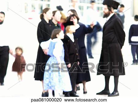 Stock Image - Israel, Jerusalem, people standing in street, blurred. Fotosearch