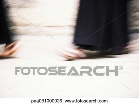 Stock Photograph - Israel, Jerusalem, procession, close up of feet walking, blurry.. Fotosearch