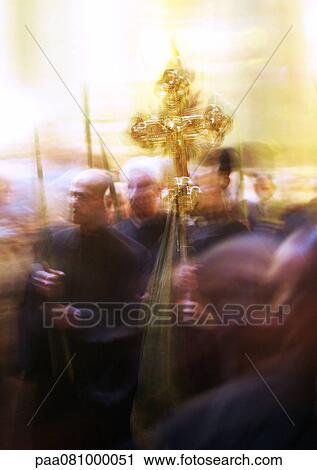 Stock Image - Israel, Jerusalem, procession with cross at the Church of the Holy Sepulchre, blurry.. Fotosearch