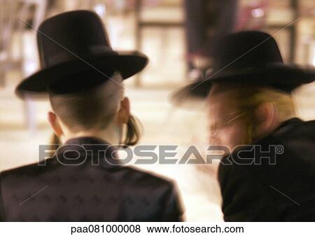 Stock Photo - Israel, Jerusalem, two Orthodox Jews conversing, blurred motion. Fotosearch