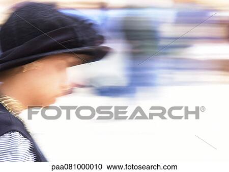 Stock Image - Israel, Jerusalem, woman wearing hat, blurred. Fotosearch