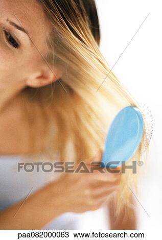 Partial view of woman brushing hair, blurred, close-up View Large Photo Image Stock Image - Partial view of woman brushing hair, blurred, close-up. Fotosearch