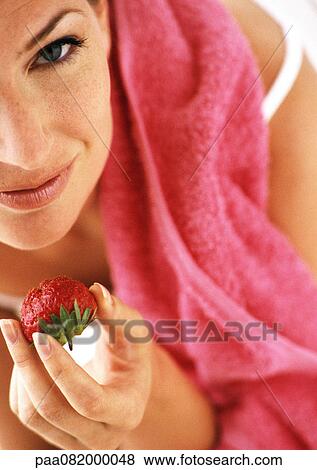 Partial view of woman holding strawberry, high angle view, close-up View Large Photo Image Stock Photo - Partial view of woman holding strawberry, high angle view, close-up. Fotosearch