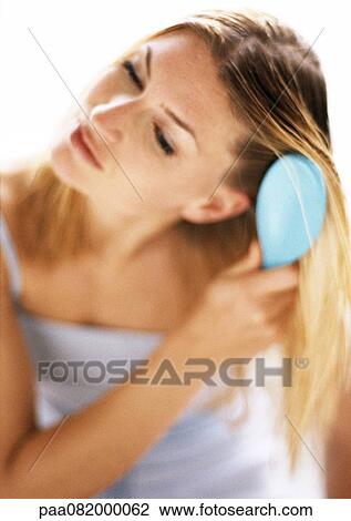 Woman brushing hair, blurred View Large Photo Image Stock Image - Woman brushing hair, blurred. Fotosearch