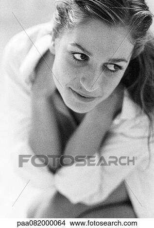 Picture - Woman holding neck with hands looking away, B&W.. Fotosearch