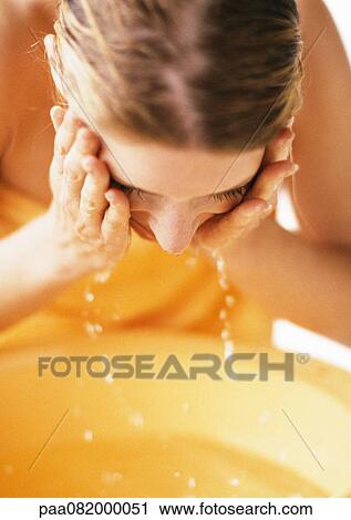 Woman leaning forward, washing face, close-up View Large Photo Image Stock Image - Woman leaning forward, washing face, close-up. Fotosearch