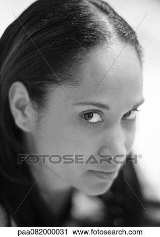 Stock Image - Woman looking at camera, portrait, B&W.. Fotosearch