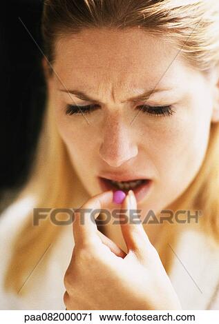 Woman putting pill in mouth, close-up View Large Photo Image Stock Image - Woman putting pill in mouth, close-up. Fotosearch