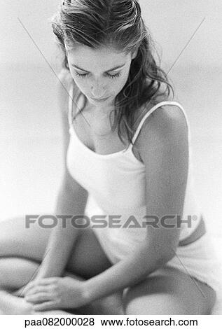 Woman sitting indian style, looking down, B&W. View Large Photo Image Stock Photo - Woman sitting indian style, looking down, B&W.. Fotosearch