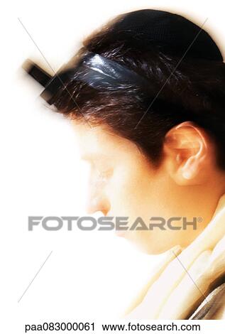 Close up of Jewish man wearing Tefillin, blurry. View Large Photo Image Stock Image - Close up of Jewish man wearing Tefillin, blurry.. Fotosearch