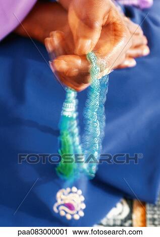 Close up of woman's hands holding prayer beads View Large Photo Image Stock Image - Close up of woman's hands holding prayer beads. Fotosearch